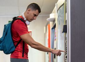 Normal_athlete-in-gym-consuming-drink-from-food-vending-m-2023-01-10-07-00-25-utc__1_