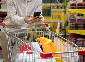 Normal_young-man-scrolling-in-smartphone-over-shopping-ca-2021-09-24-03-45-21-utc__1_