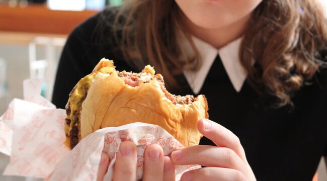 Carousel_teenager-girl-eating-a-hamburger-and-fries-for-lun-2022-11-15-16-54-13-utc__1_